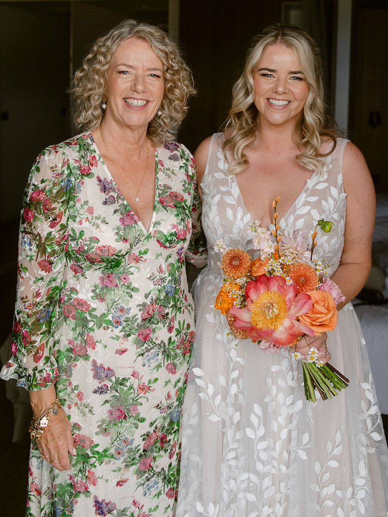 Bride in wedding dress smiling with her mother on wedding day in Split, both wearing makeup by Katarina Ramic.