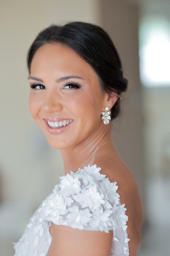 Smiling bride Monika looking at photographer during wedding morning in Split, getting ready at Hotel Cvita